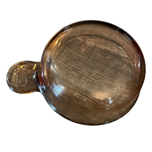 Clear glass vision bakeware with handle on a white background