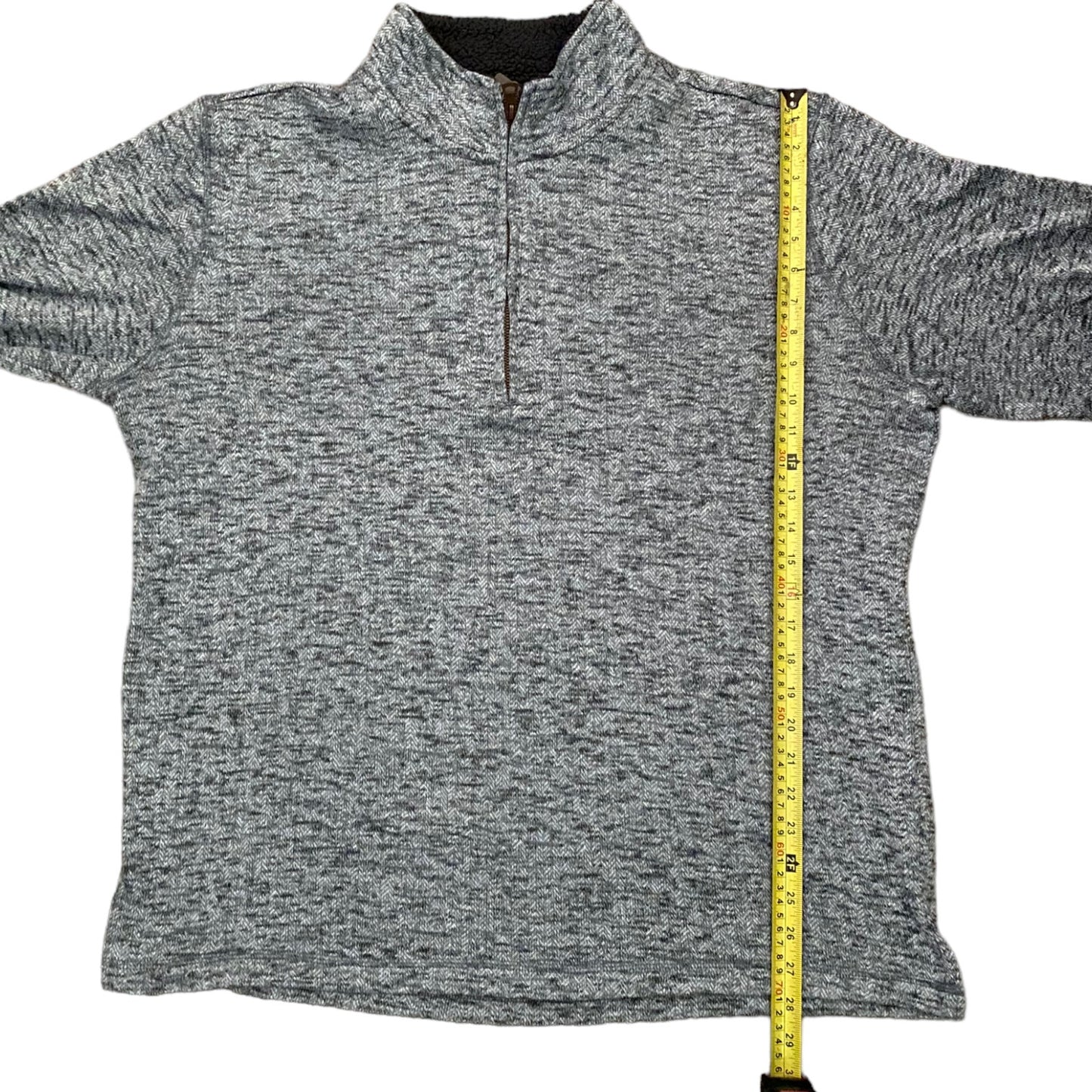 Gray sweater with a measuring tape on a white background