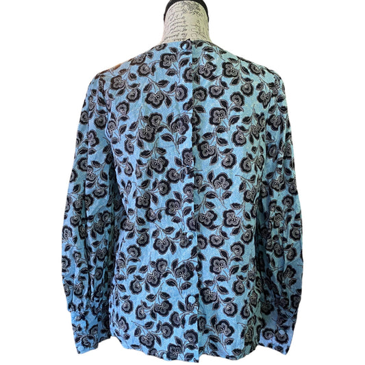 Back of Blue floral patterned shirt on a mannequin against a white background