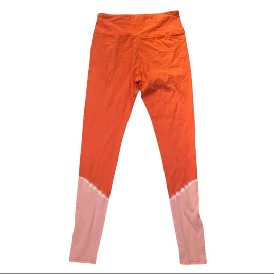 Orange and light pink tie-dye leggings shown flat against a white background.