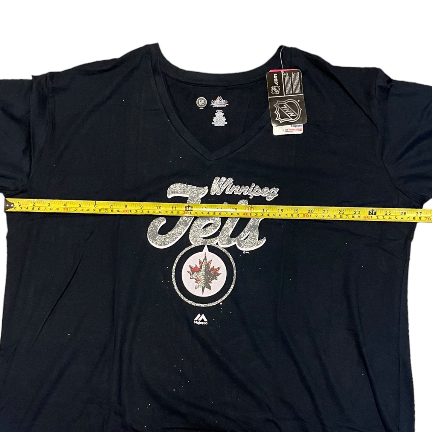 Blue t-shirt with 'Winning Jets' text and logo, measured with a tape measure.