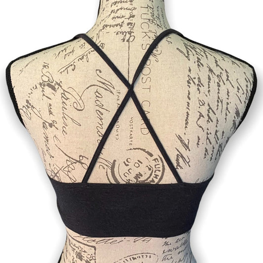 Gray strappy top shown from the back on a beige fabric dress form with cursive script print, against a white background.