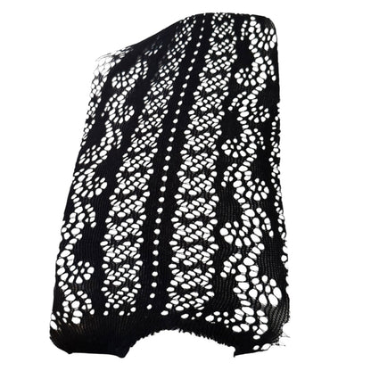 A black knit lace lingerie with a white  and geometric openwork pattern, shown against a plain white background.