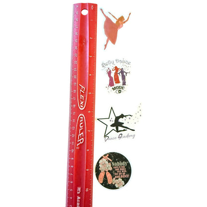Red ruler with various dance-themed stickers on a white background
