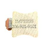 Rubber stamp with 'IMPRESS' and phone number on a white background