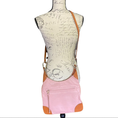 Mannequin wearing a pink crossbody with brown straps on a white background
