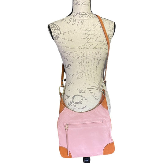 Mannequin wearing a pink crossbody with brown straps on a white background