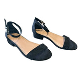 Pair of black faux suede shoes on a white background