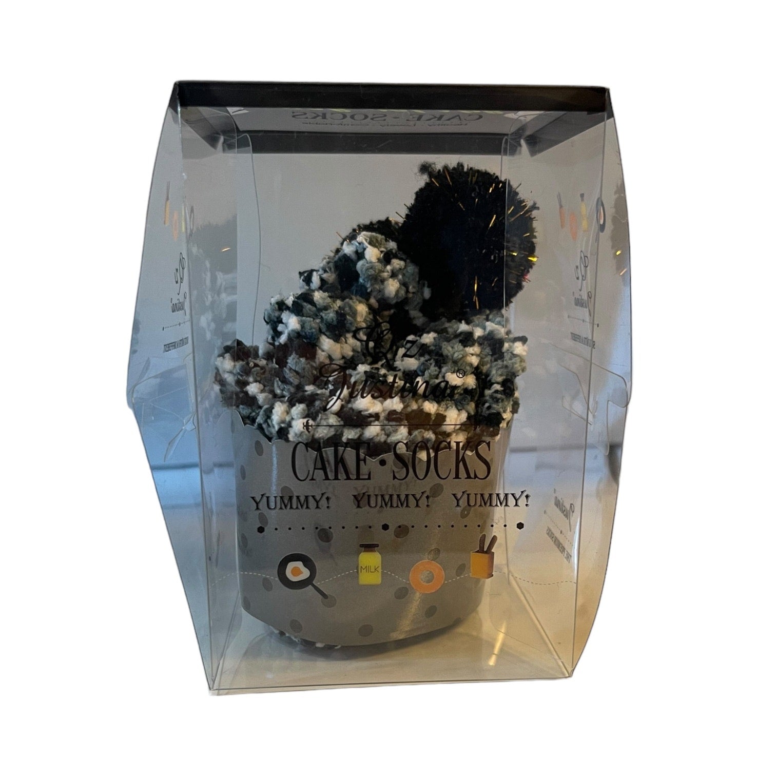 Packaged cake-shaped socks with a clear box on a white background