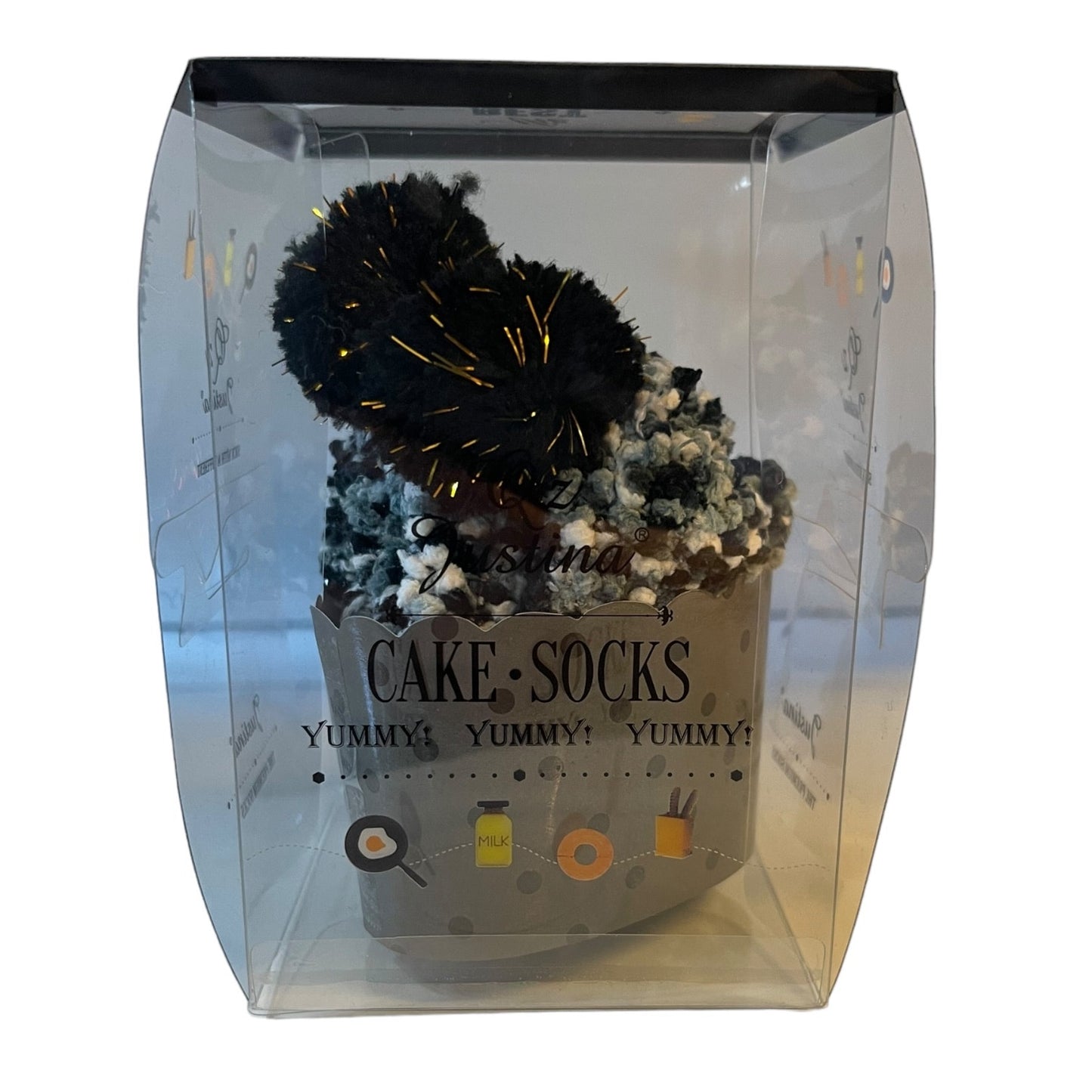 Clear packaging with decorative cake socks and text on a white background