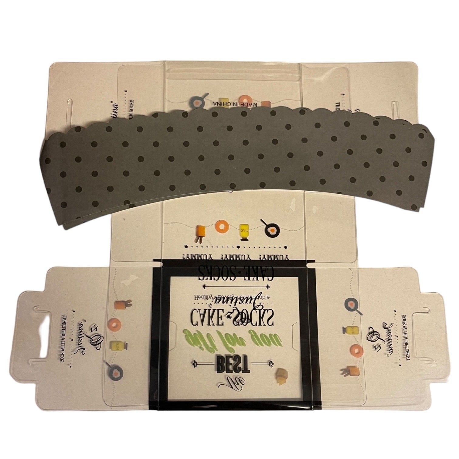 Plastic product packaging with a decorative flap and printed design on a white background