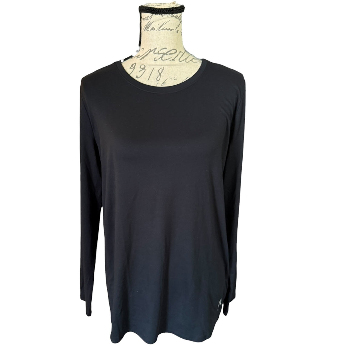 A black long-sleeve top displayed on a cream-colored dress form mannequin against a plain white background.