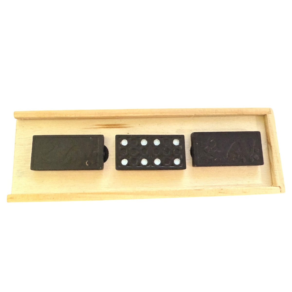 Wooden tray with three black dominoes on a white background
