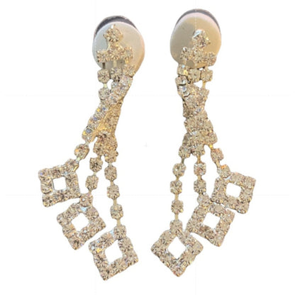 A pair of silver-tone drop earrings embellished with clear rhinestones in a drop design, shown against a plain white background.