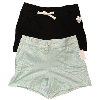 Black and light green shorts with tags on a white background