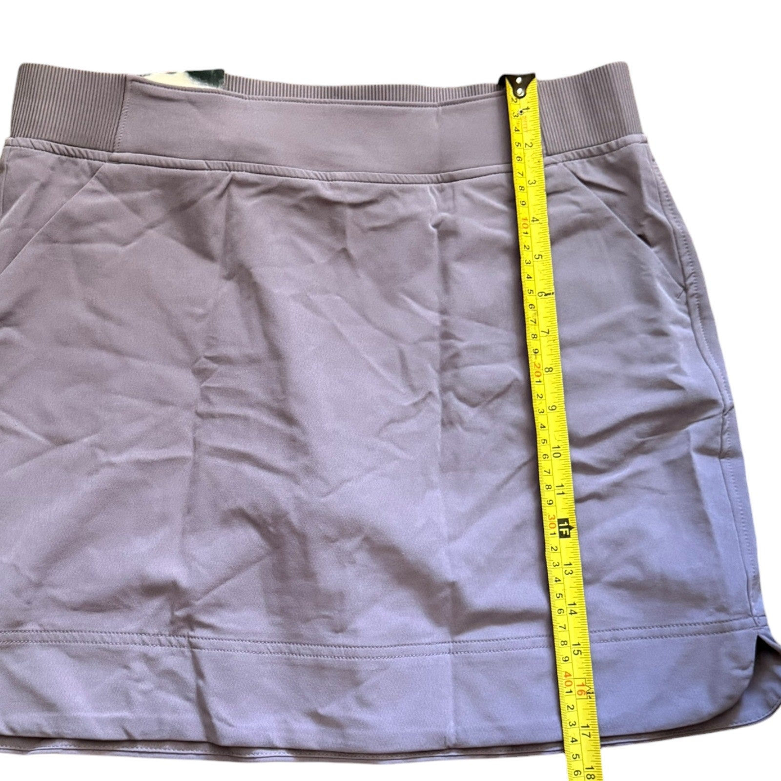 Purple skirt with a yellow measuring tape on a white background