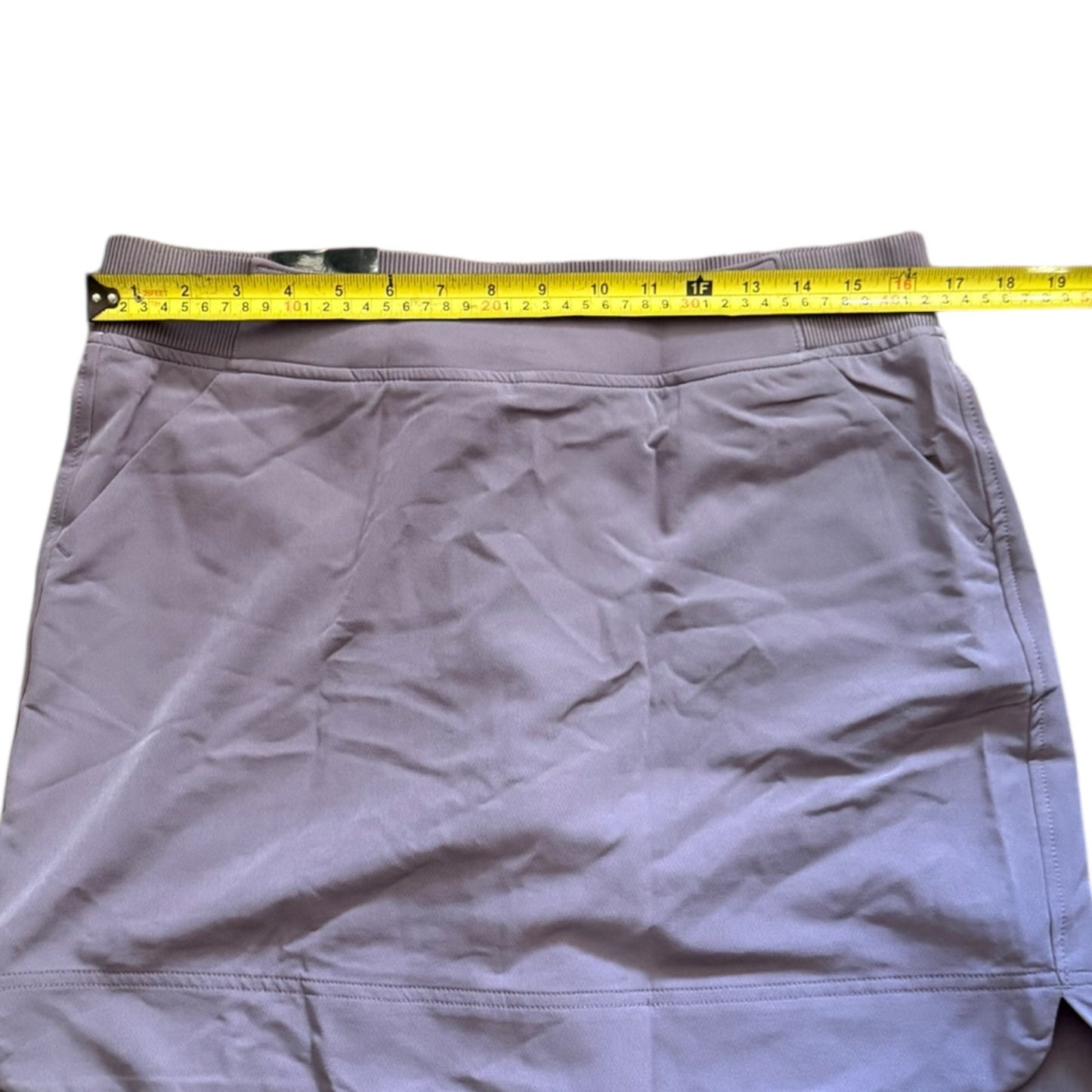 Purple skirt with a measuring tape on a white background