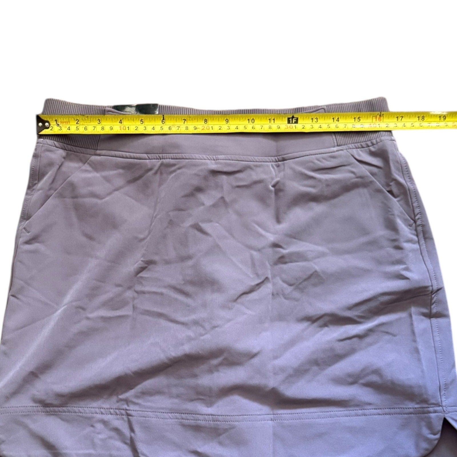 Purple skirt with a measuring tape on a white background