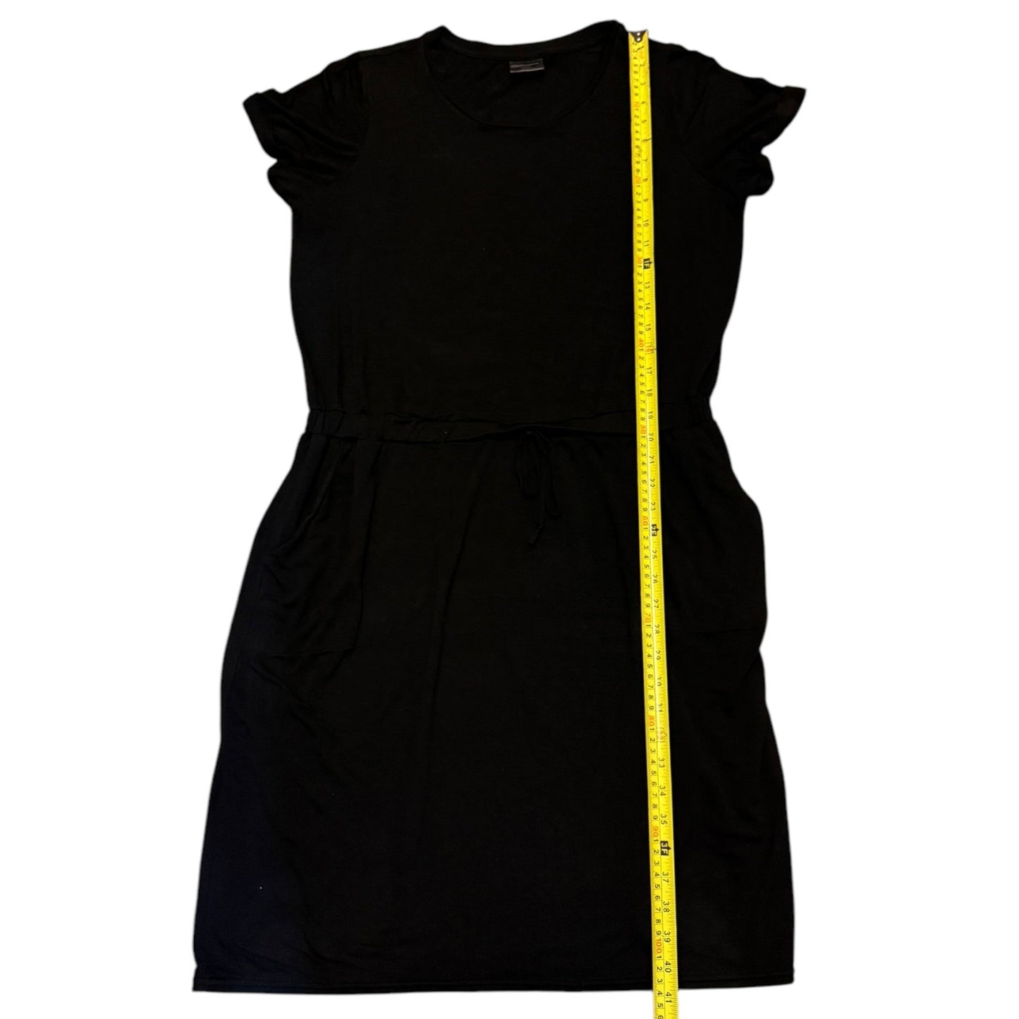 Black dress with a measuring tape displayed on a white background