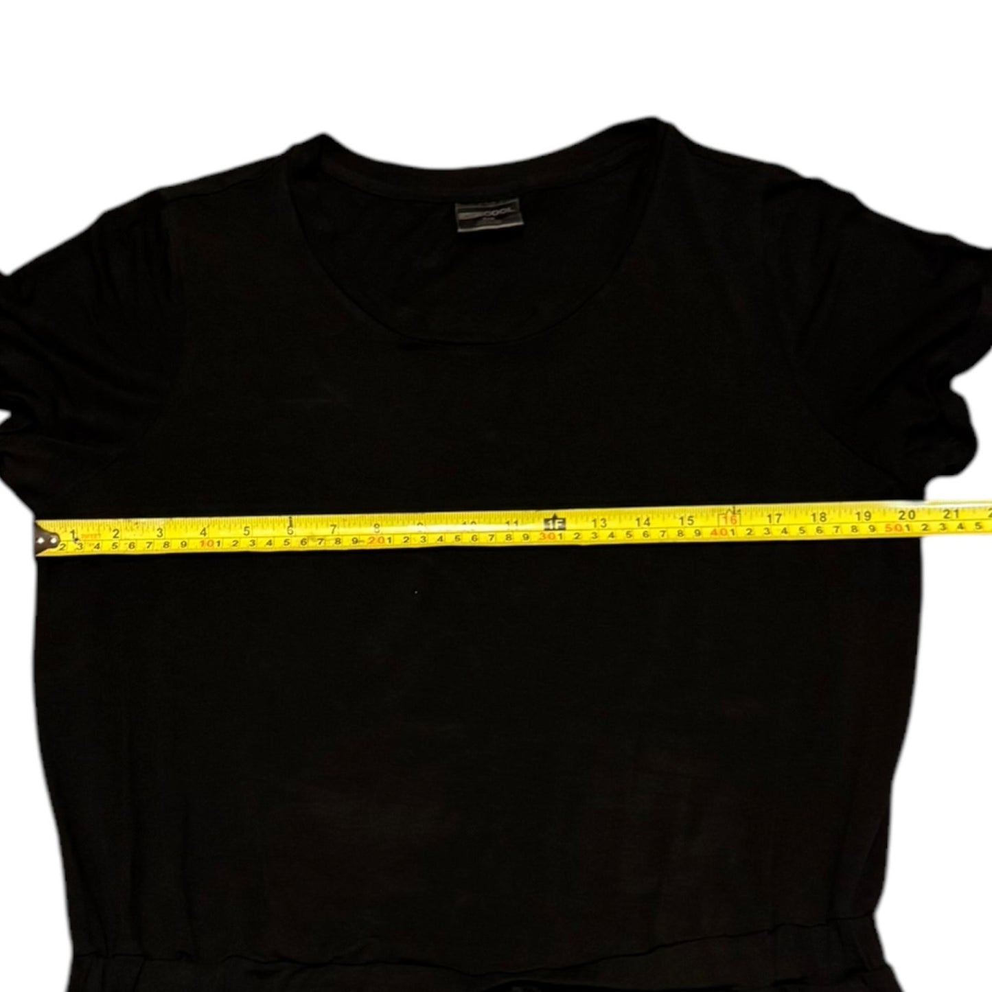 Black dress with a yellow measuring tape across it on a white background