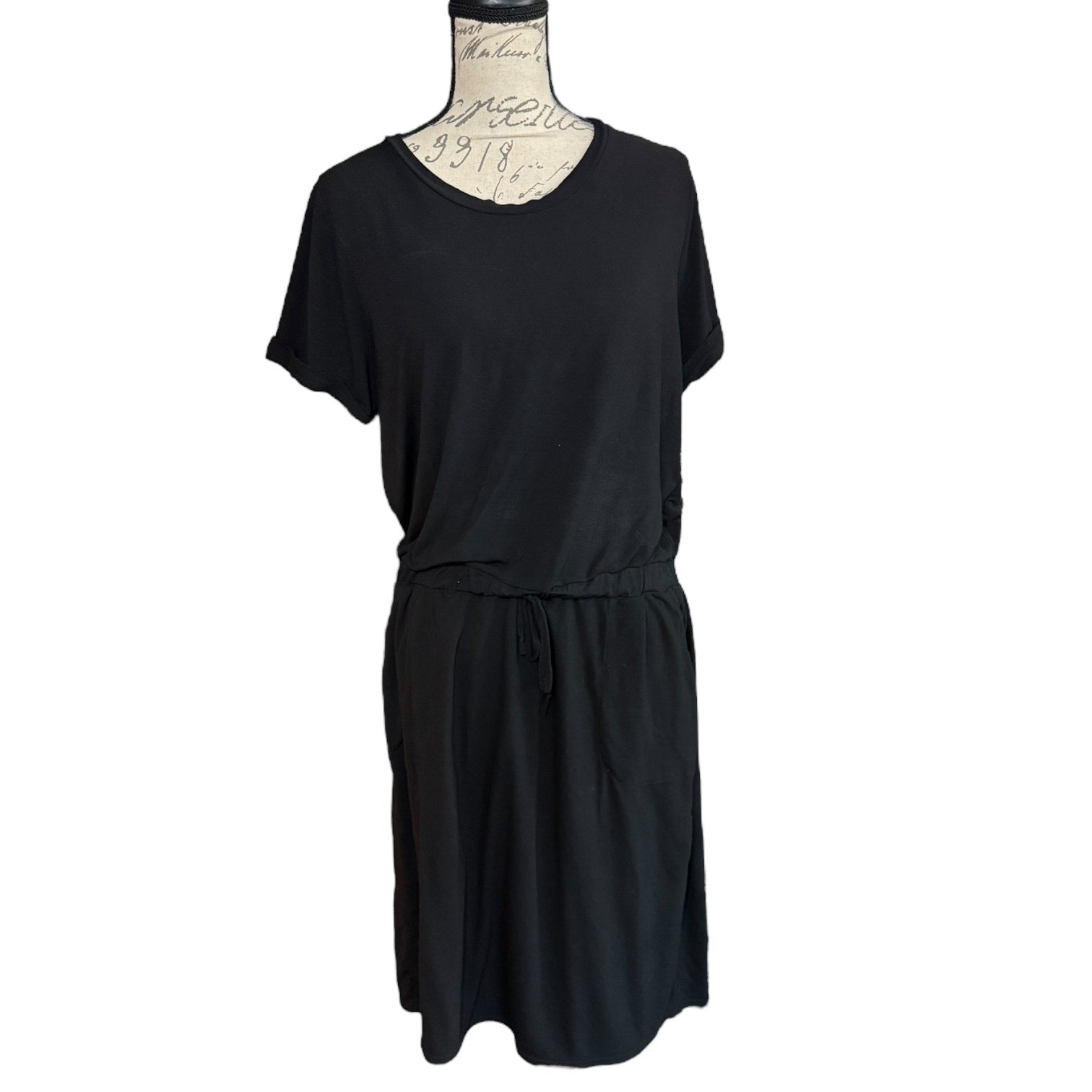 Black dress on a mannequin against a white background