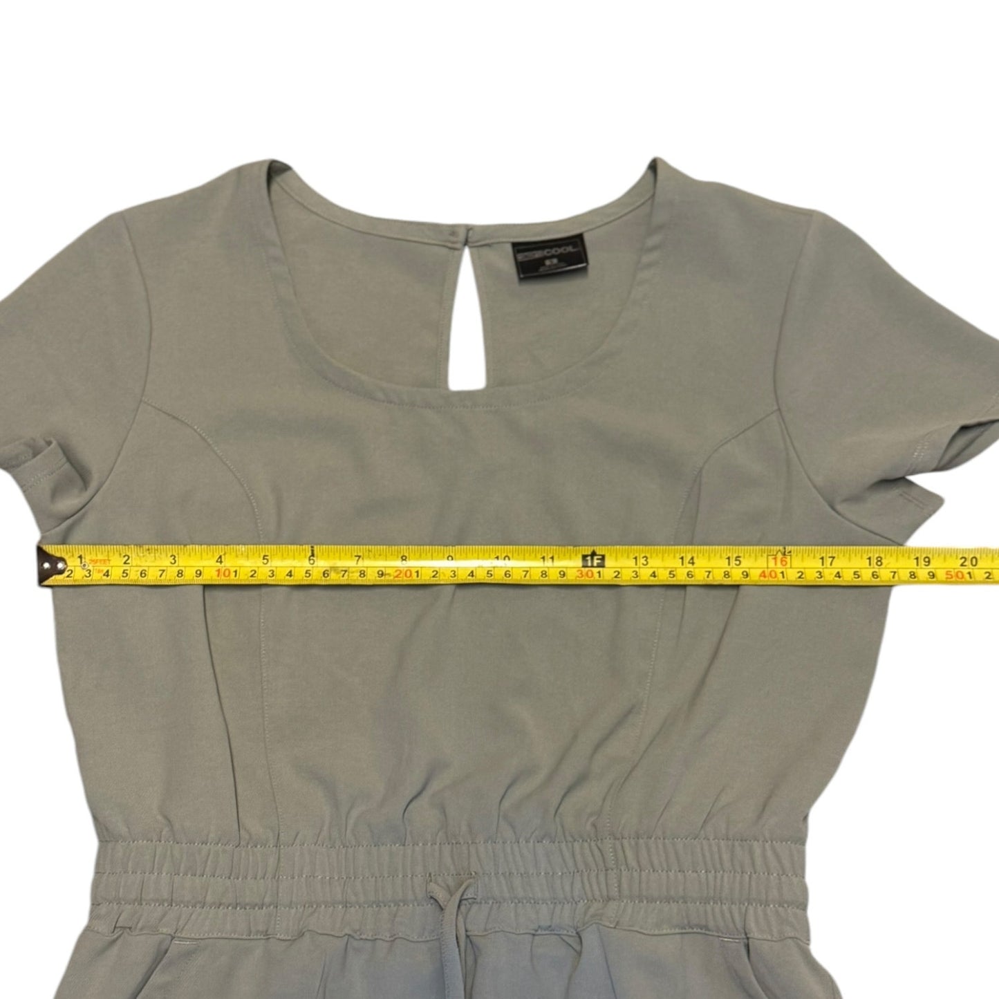 Gray dress with a measuring tape across it on a white background