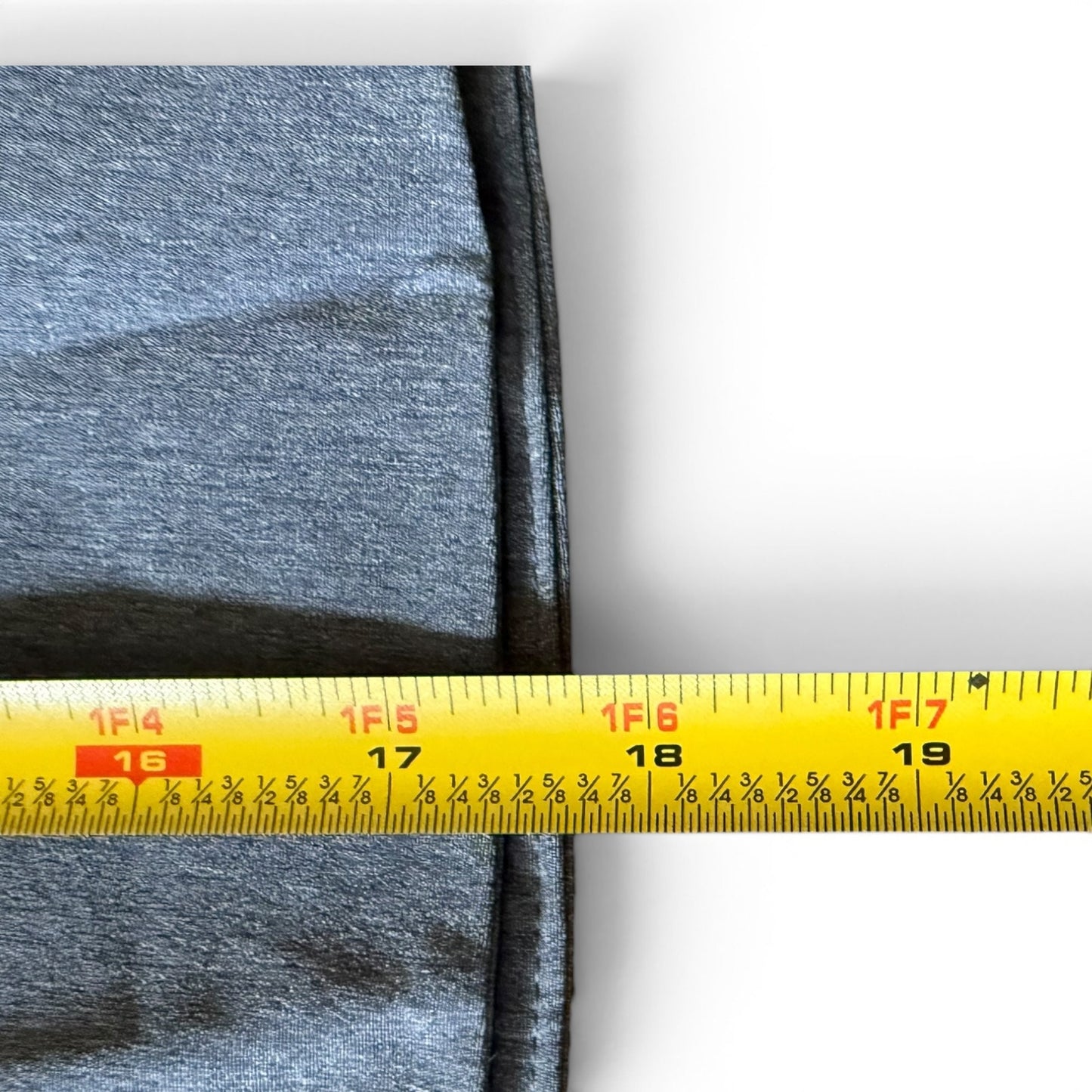 blue skort with a yellow measuring tape showing measurements