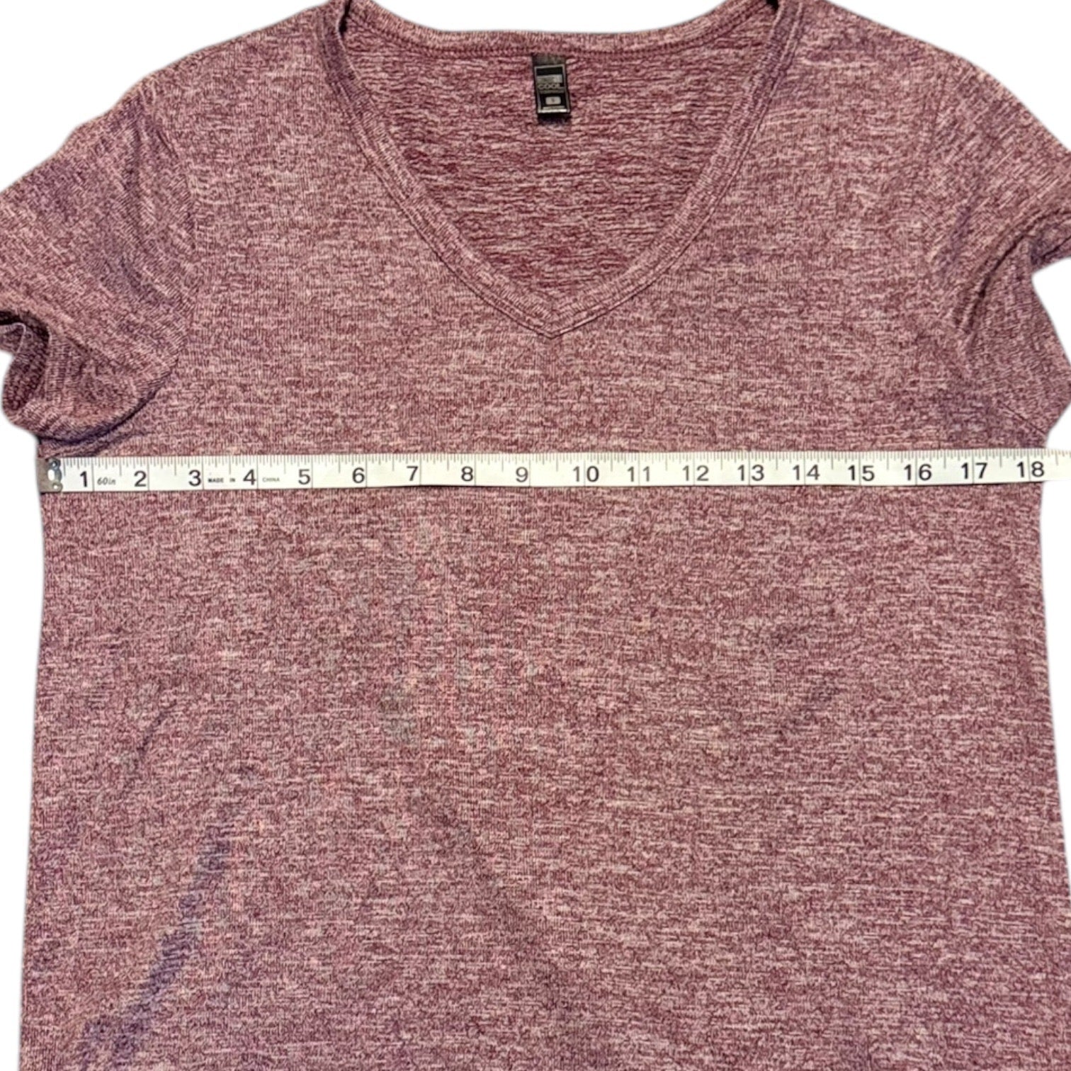 Red t-shirt with a measuring tape at the bottom on a white background
