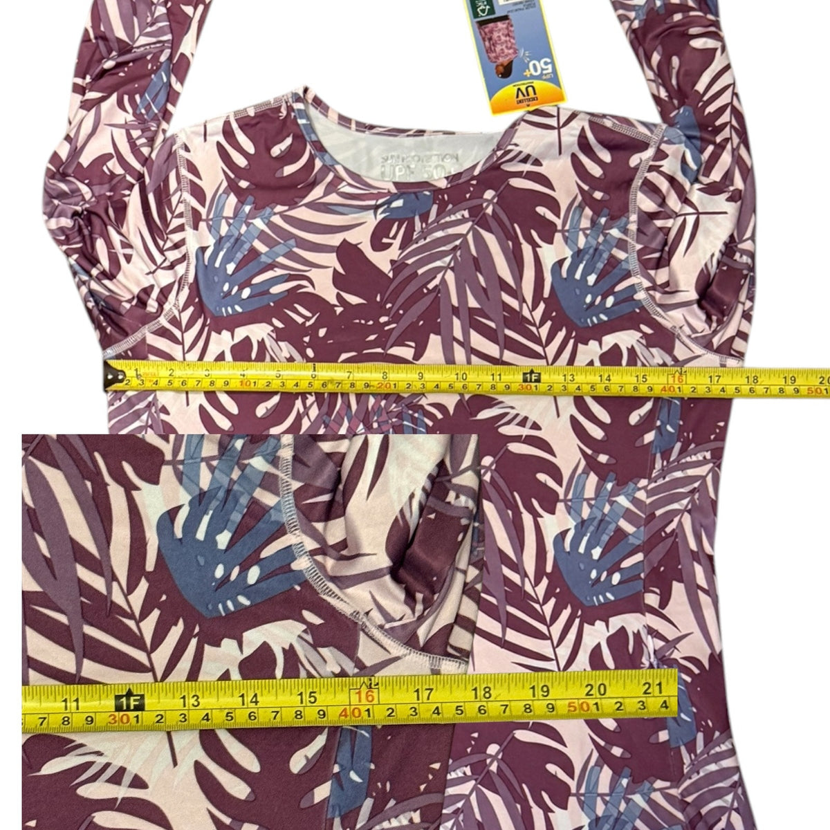 Tropical leaf patterned top with a measuring tape for size reference on a white background