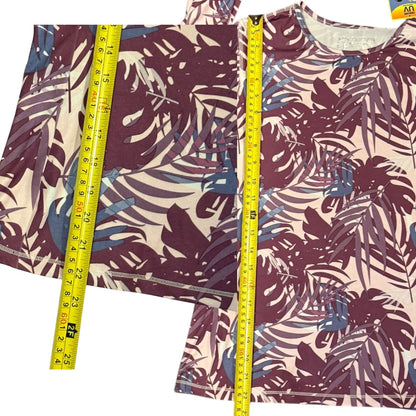 Tropical leaf patterned shirt with a measuring tape on a white background