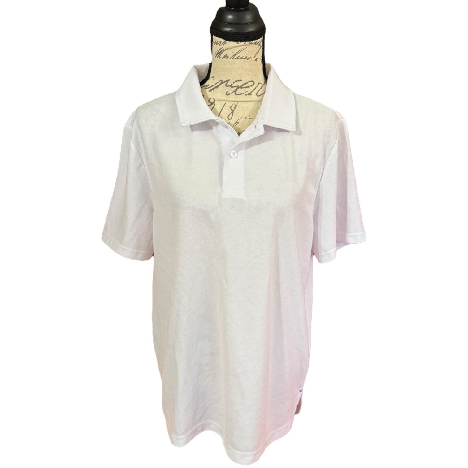 Front of White polo shirt on a mannequin with a white background