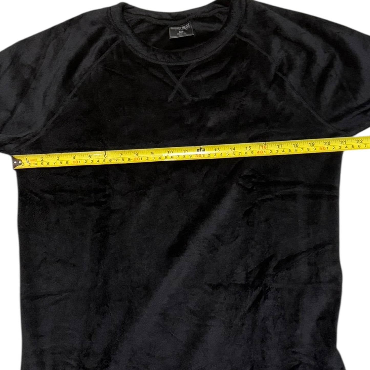 Gray shirt with a yellow measuring tape around the chest area on a white background