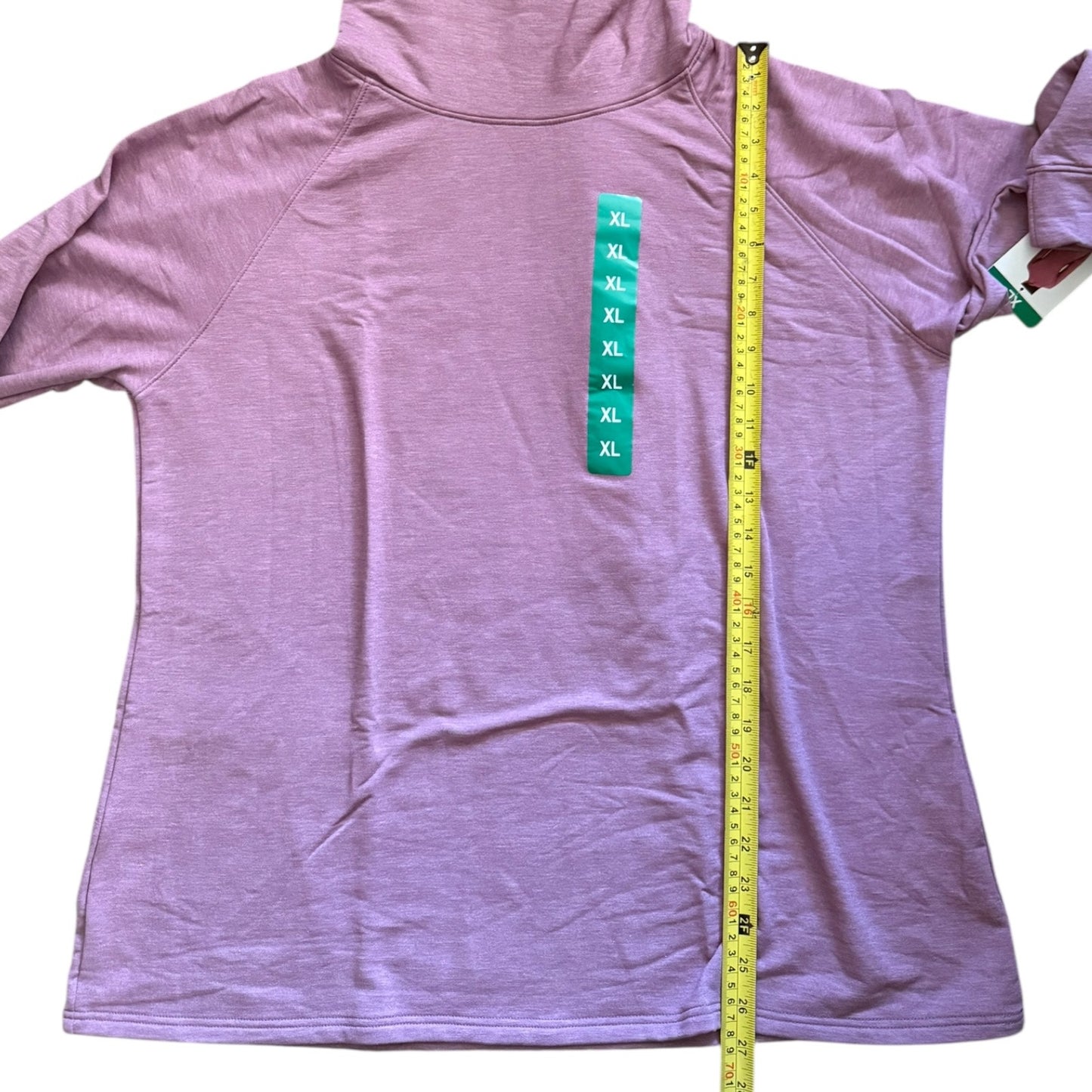 Pink sweater with a measuring tape and size chart on a white background