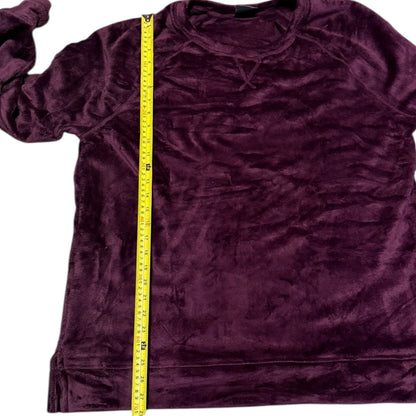 A purple long-sleeve velour shirt shown flat on a white background with a yellow measuring tape vertically aligned to indicate its size.