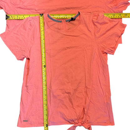 Coral shirt with a measuring tape displayed on a white background