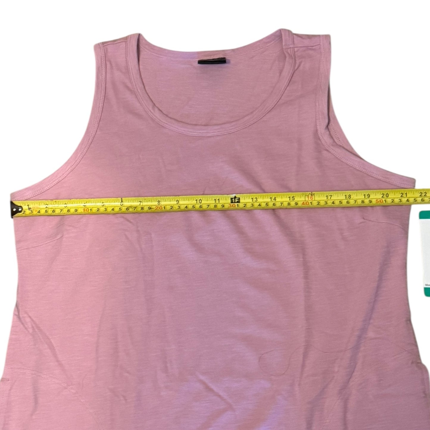 Pink dress with a measuring tape on a white background