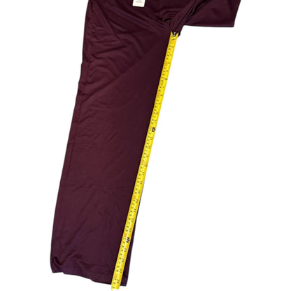 Purple pants with a yellow measuring tape on a white background