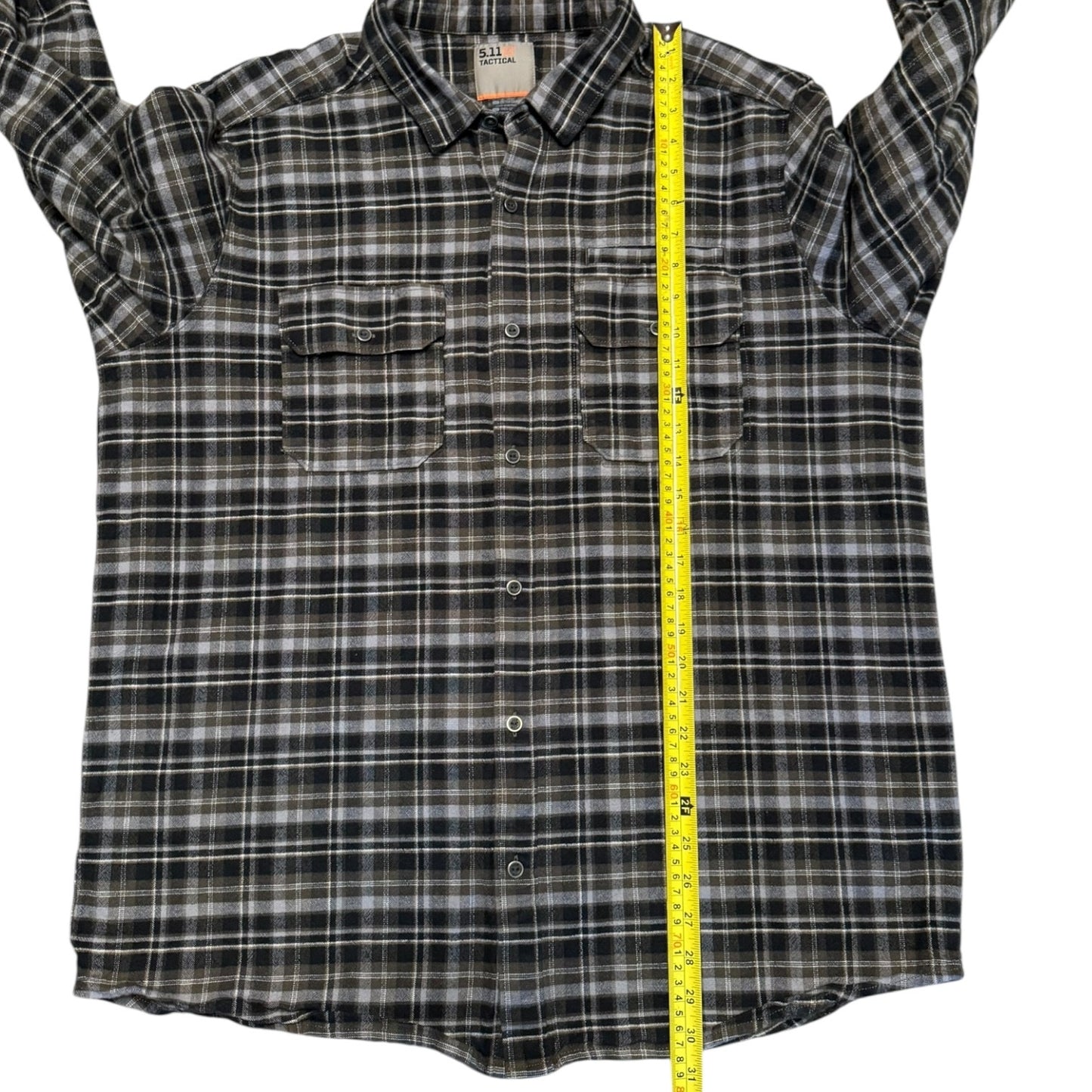 Plaid shirt with a measuring tape displayed on a white background
