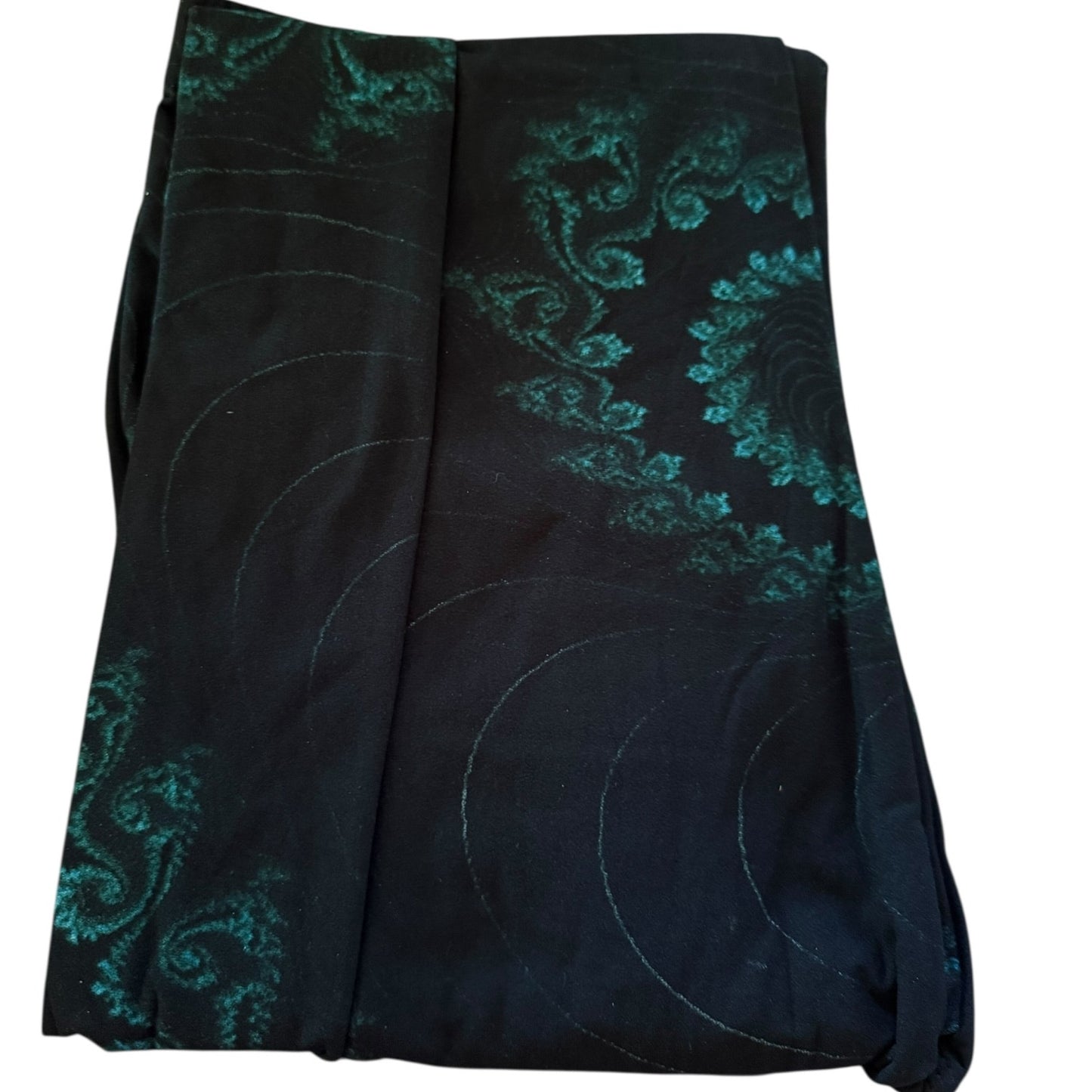 Black leggings with green swirl patterns on a white background