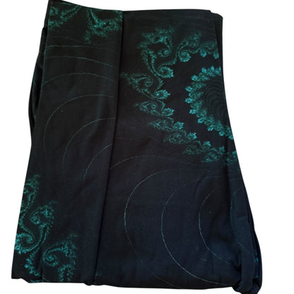 Black leggings with green swirl patterns on a white background