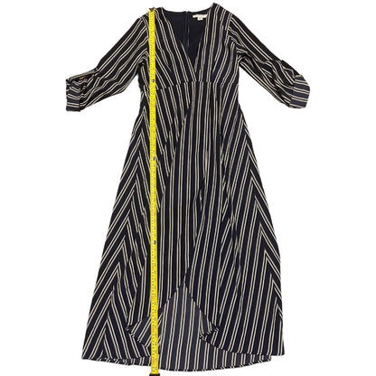 A blue midi dress with vertical white stripes and a yellow measuring tape draped down the front, shown against a plain white background.