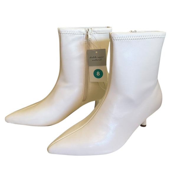 Front side White ankle boots with a visible brand tag on a white background