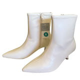 Front side White ankle boots with a visible brand tag on a white background