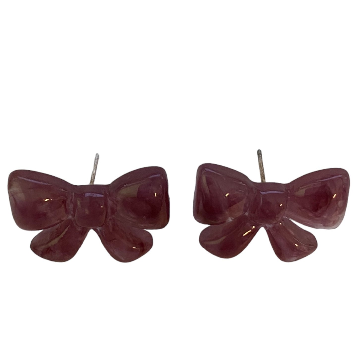 Pair of purple bow-shaped earrings on a white background