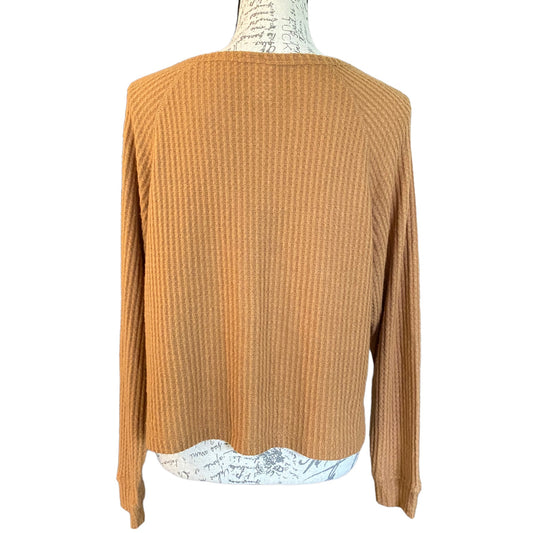 Back of brown top on a mannequin against a white background