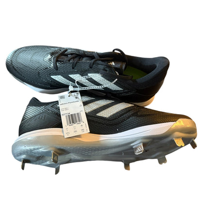 Black Adidas sports shoes with cleats on a white background side view