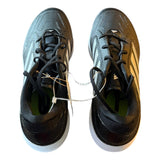 Pair of black athletic shoes with white soles on a white background top view 