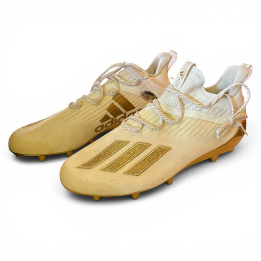 Pair of Adidas soccer cleats on a white background