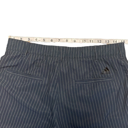 Pinstripe pants with a tape measure on a white background