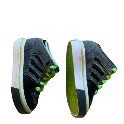 Pair of black and green sneakers on a white background